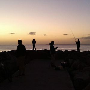 Silhouette of fishermen at dusk.