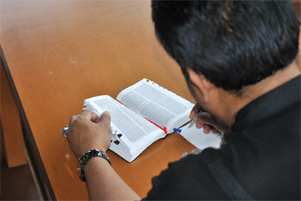 A man studying the Bible and taking notes.