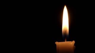 a-lit-candle-with-a-long-wick-having-shimmering-flame-at-night_hs97f5obg_thumbnail-small01.jpg
