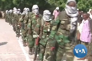 Al-Shabaab militants marching in a line.