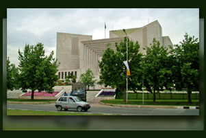 Supreme Court of Pakistan building with trees surrounding it.