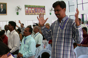 A group of Christians are praying and worshipping together.