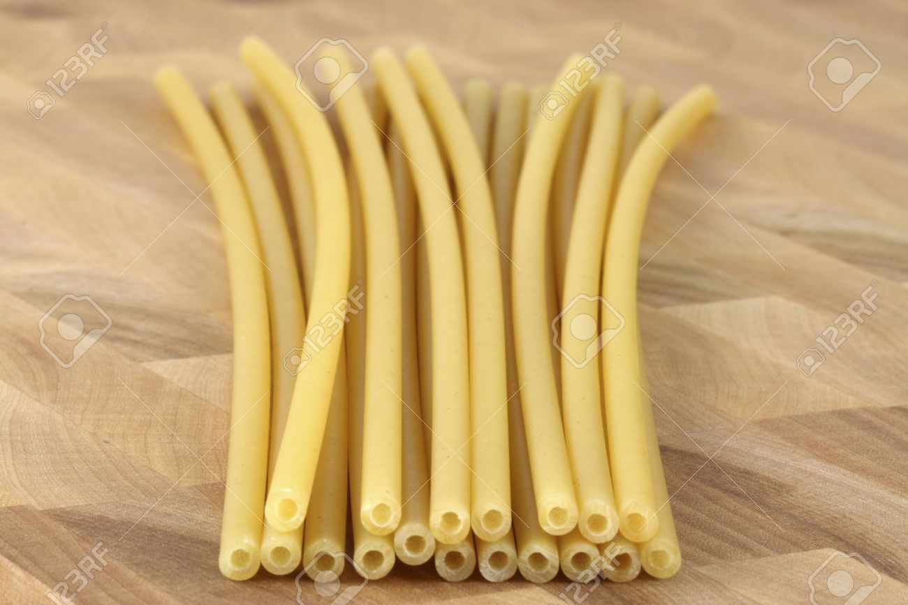 9264045-beautiful-fresh-and-raw-wholegrain-bucatini-thick-corkscrew-shaped-pasta-on-wood-board-shallow-dof.jpg