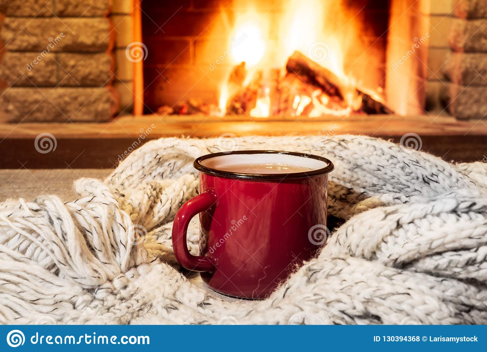 cozy-scene-near-fireplace-red-enameled-mug-hot-tea-warm-scarf-country-house-winter-vacation-ho...jpg