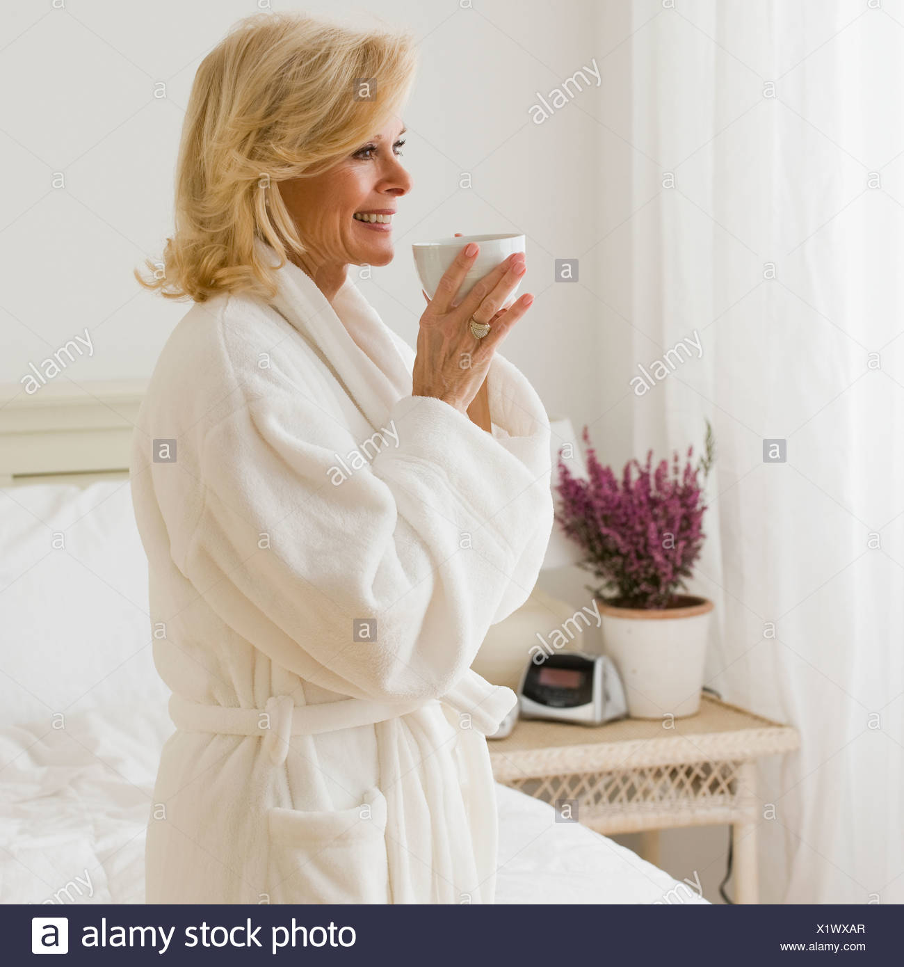 senior-woman-in-bathrobe-drinking-coffee-X1WXAR.jpg