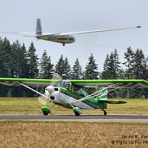 Here is the Decathlon taxiing by just as a Blanik glider is towed aloft by another airplane.