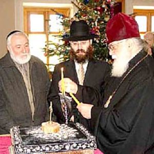 Orthodox Priest lighting Georgian menorah