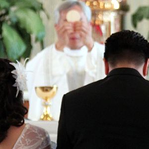 Wedding Kneeling Before Eucharist