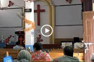 Screenshot from video with play button.