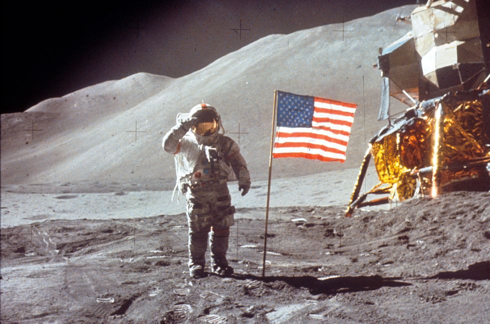 astronaut david scott salutes by us flag