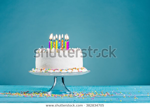 white-birthday-cake-over-blue-600w-382834705.jpg