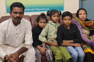 Shaukat, Kiran, and their three children are sitting together.