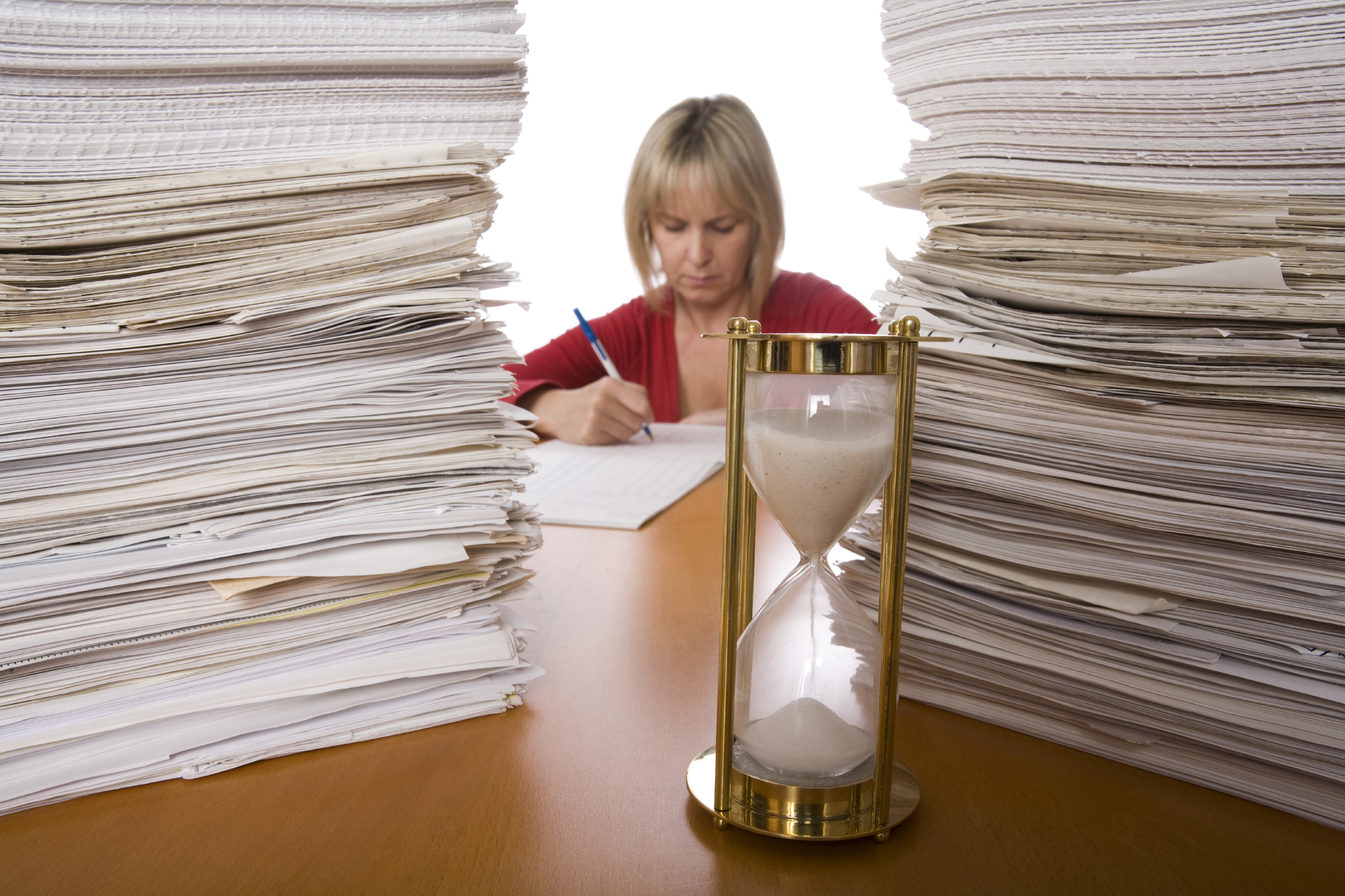 Woman-with-piles-of-paper-and-hourglass.jpg