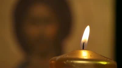 stock-footage-lighting-candle-in-front-of-jesus-christ-orthodox-icon-praying-moment.jpg