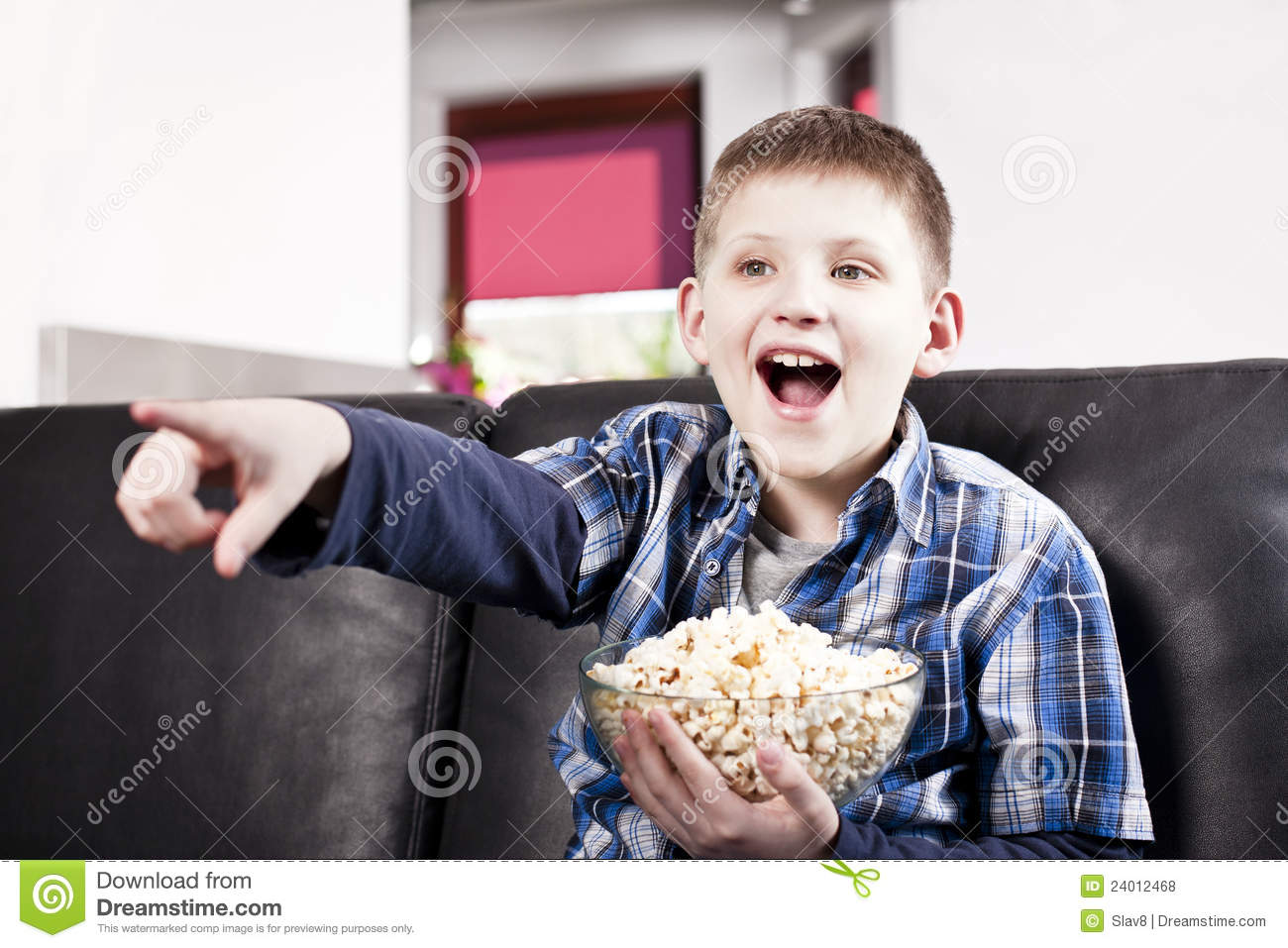 blond-happy-boy-watching-tv-eating-popcorn-24012468.jpg