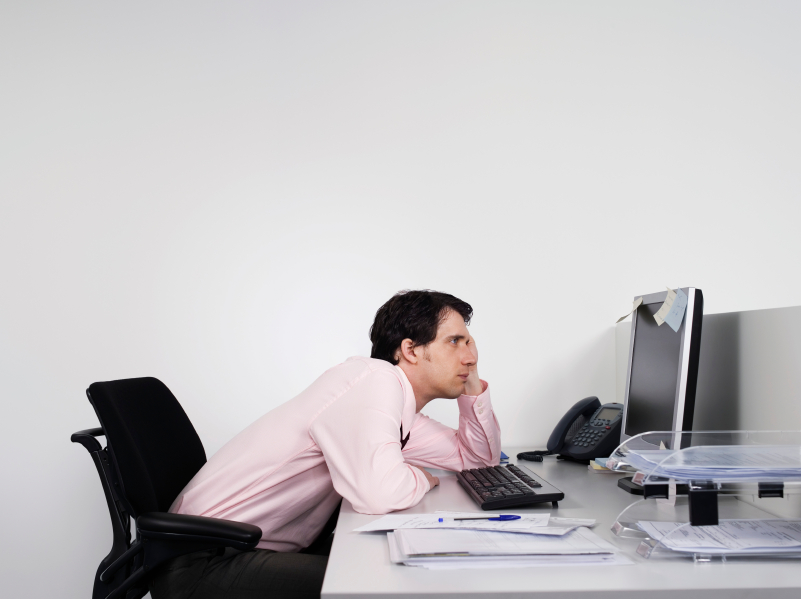 Bored-Male-Office-Worker-At-Desk.jpg