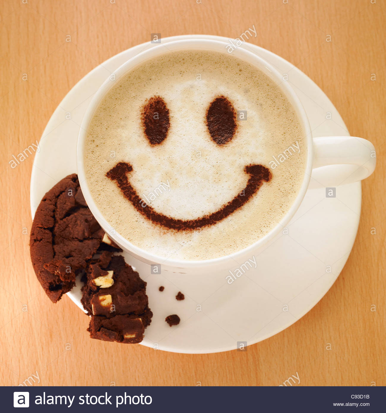 cappuccino-coffee-with-smiley-face-in-chocolate-powder-and-a-cookie-C93D1B.jpg