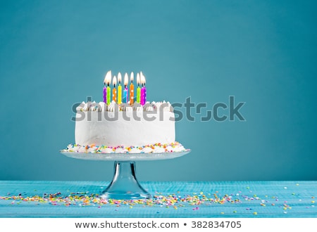 white-birthday-cake-over-blue-450w-382834705.jpg