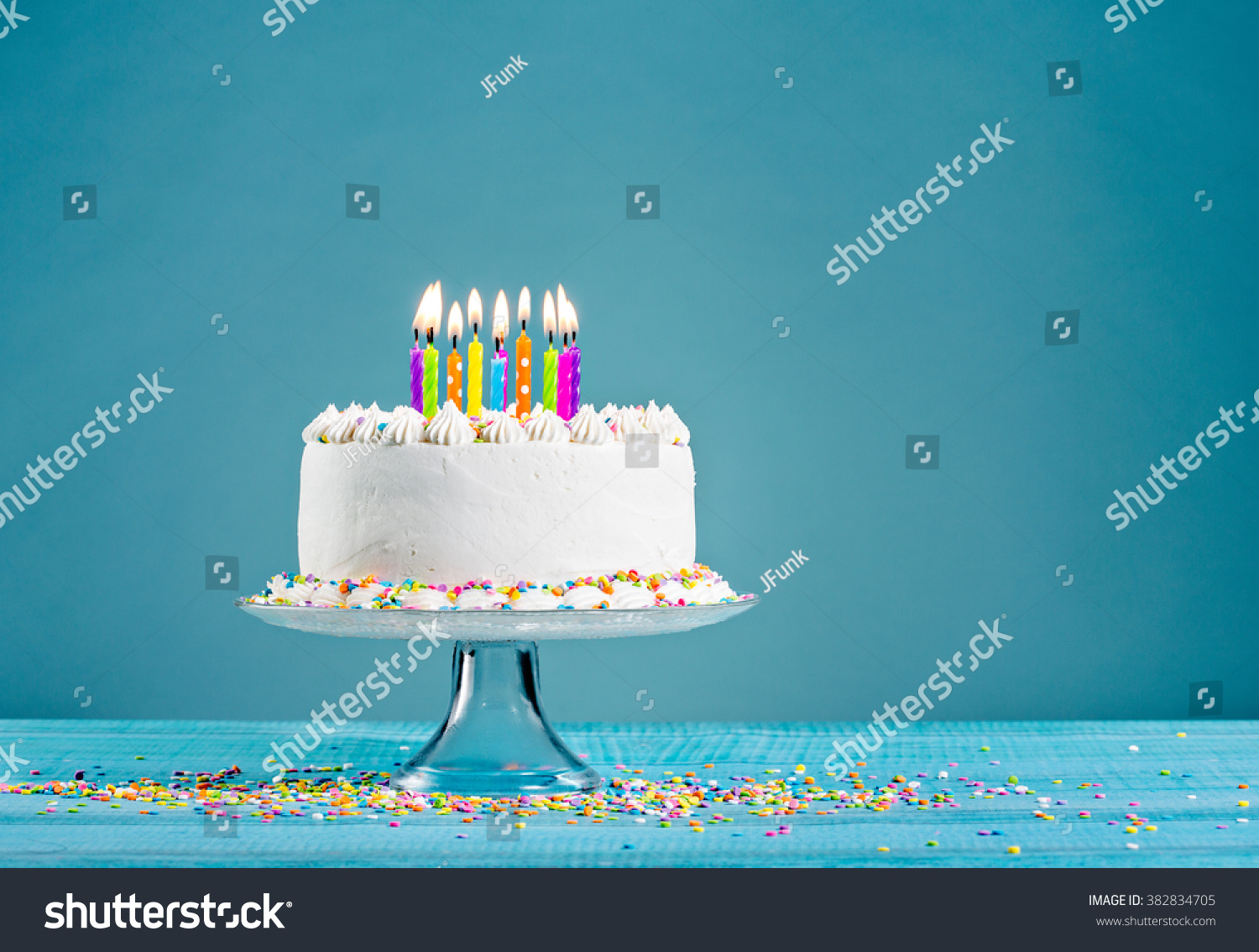 stock-photo-white-birthday-cake-over-blue-background-382834705.jpg