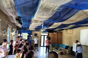 A group of people are standing inside a building. 