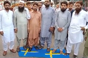 Men standing on flags of Sweden.