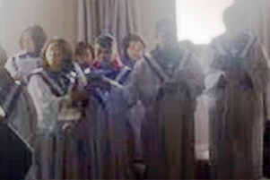 Cell phone video screenshot of choir singing.