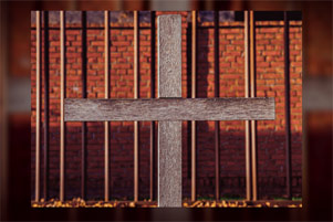 Prison walls with cross in the foreground