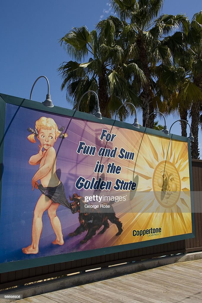 cleaned-up-version-of-the-famous-coppertone-billboard-greets-visitors-picture-id98698906