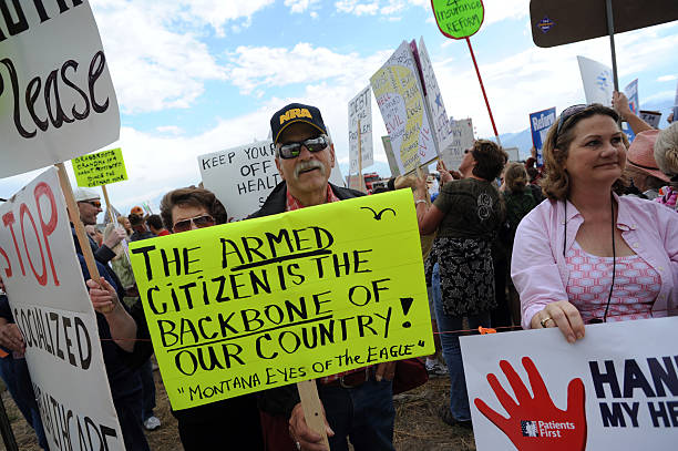 peter-drowne-of-big-fork-montana-protests-outside-a-town-hallstyle-picture-id89799808