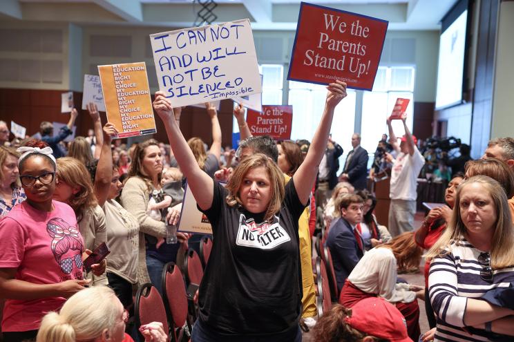 Shelley Slebrch and other angry parents and community members protest after a Loudoun County School Board meeting was halted by the school board because the crowd refused to quiet down, in Ashburn, Virginia, U.S. June 22, 2021.