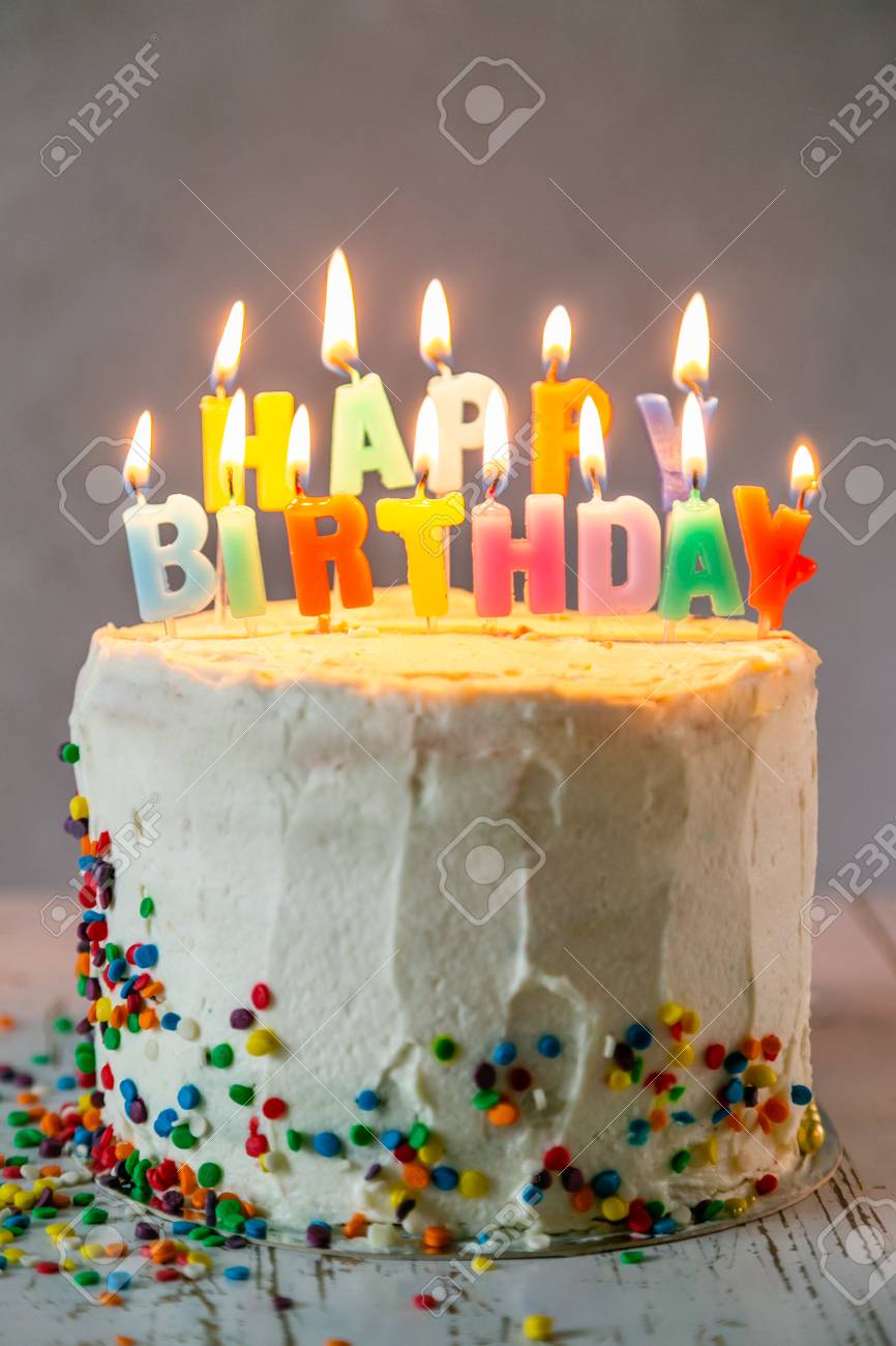 113299483-colorful-birthday-concept-cake-candles-presents-decorations-neutral.jpg