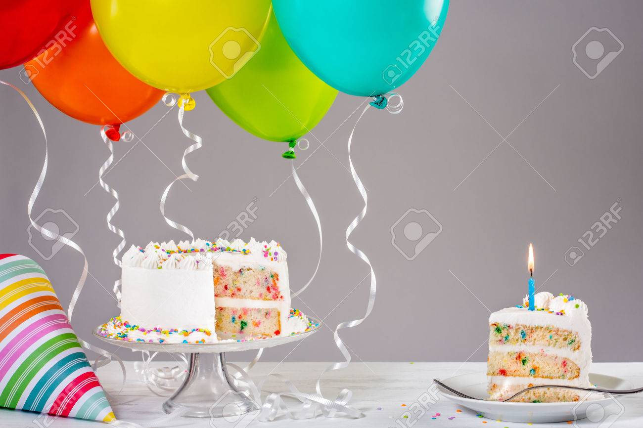 52937249-white-buttercream-birthday-cake-with-colorful-balloons-and-hat-.jpg