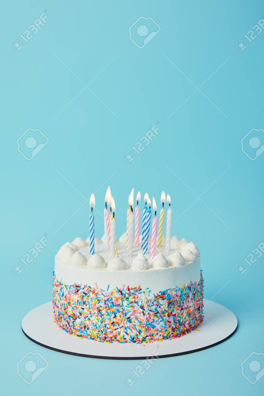 112251085-tasty-birthday-cake-with-lighting-candles-on-blue-background.jpg