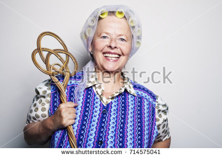 stock-photo-senior-woman-with-curler-and-old-fashioned-coat-holding-carpet-beater-714575041.jpg