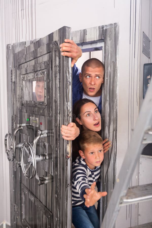 scared-family-trying-to-get-room-bunker-door-astonished-scared-young-men-women-two-teen-boys-trying-to-253999833.jpg