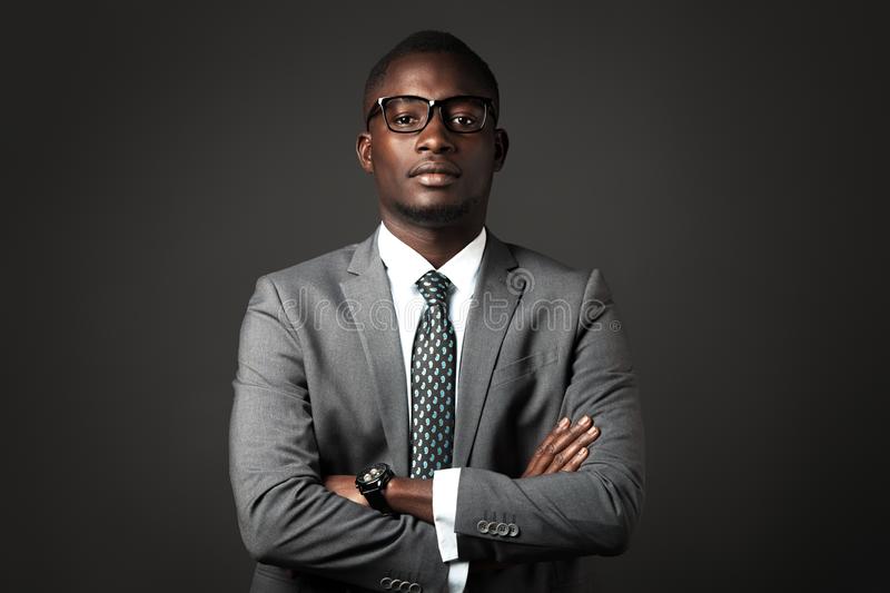 serious-young-black-man-glasses-gray-business-suit-cros-serious-young-black-man-glasses-gray-business-suit-130576491.jpg