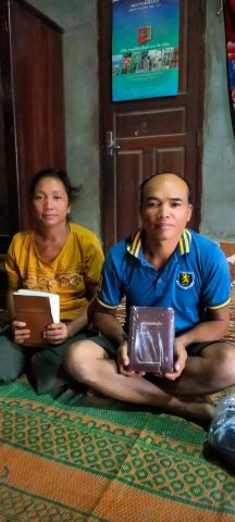 Sed and his wife joyfully received new Bibles from a front-line worker.